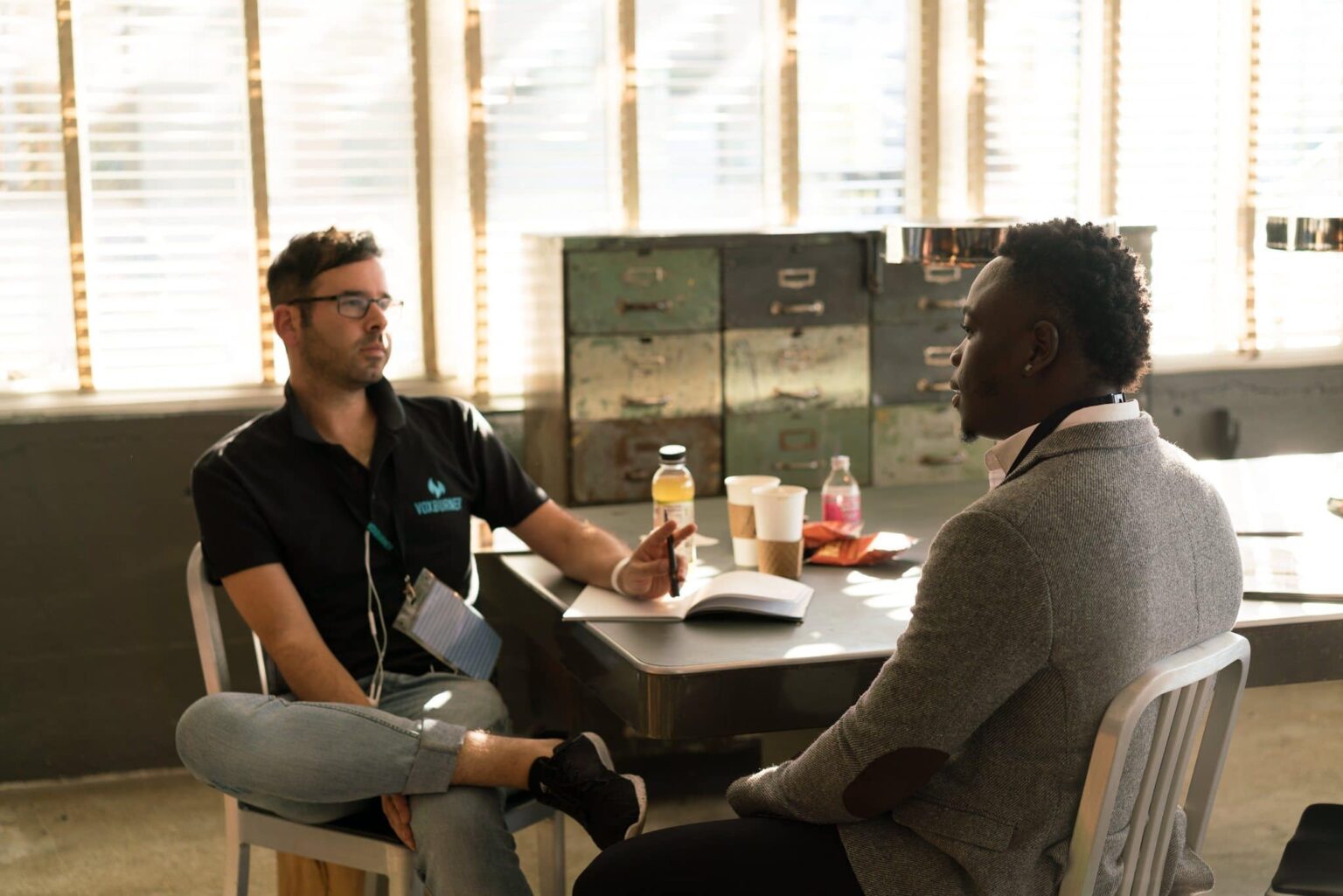 A group of people sitting at a table talking.